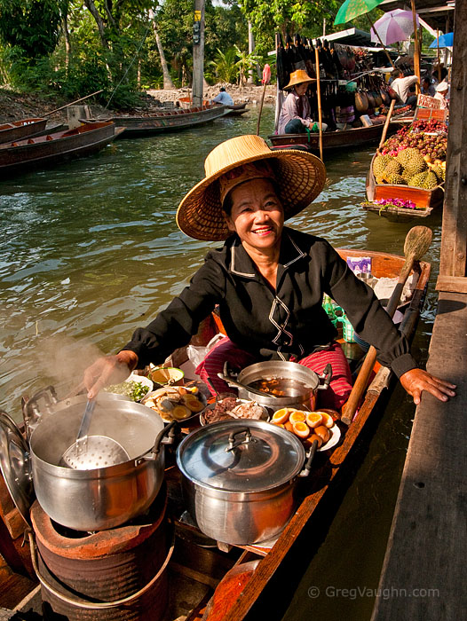 Woman selling food from boat at Damnoen Saduak Floating Market in Ratchaburi, Thailand