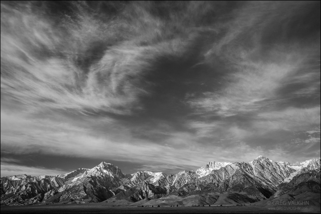 Black and white photo of clouds over Sierra Nevada Mountains from Owens Valley, California.